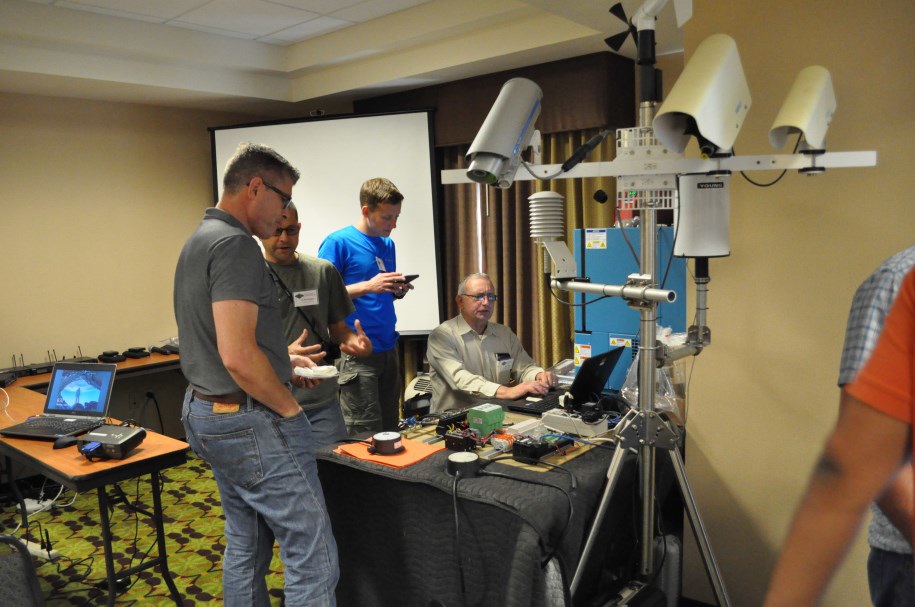 Speakers Jeff Worthington and Mike Beyer from Caltrans District 2, discuss and demonstrate their redesigned RWIS RPU, and in-pavement and out-of-pavement sensors and their associated software. (2016) Speakers Jeff Worthington and Mike Beyer from Caltrans District 2, discuss and demonstrate their redesigned RWIS RPU, and in-pavement and out-of-pavement sensors and their associated software. (2016)
