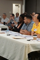 Terry Thompson takes a look at some equipment passed around during a technical presentation.